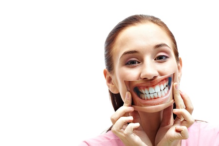 Portrait of pretty female holding the snapshot of smile by her mouthの写真素材