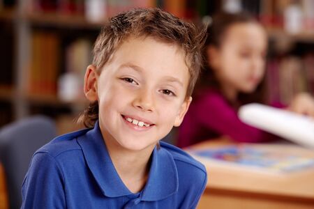 Portrait of smart lad looking at camera during lesson