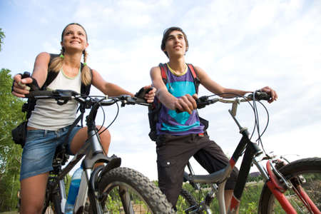 Couple of cyclers on their bikes outdoors in natural envirionmentの写真素材