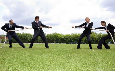 Photo of business people stretching the rope in the stadium の写真素材