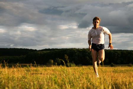 Portrait of strong man running and looking at camera  の写真素材