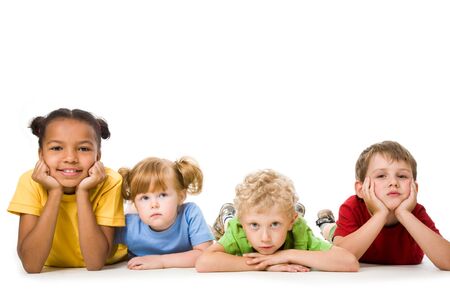 Portrait of four children lying in a line  の写真素材