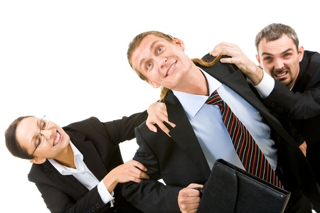 Image of businessman trying to free from his colleagues hands の写真素材