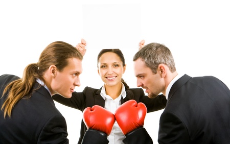Portrait of aggressive businessmen in boxing gloves with happy female with blank paper between themの写真素材