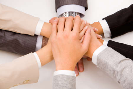 Close-up of business people’s hands on top of each other 