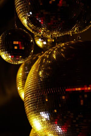 Vertical image of disco balls sparkling in darkness