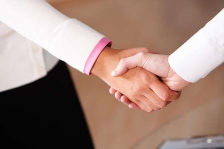 Image of partners handshake after signing contractの写真素材