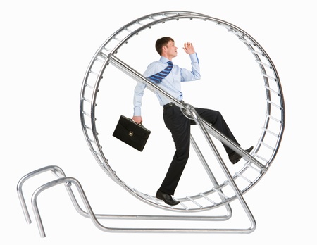 Photo of running man in metal wheel over white backgroundの写真素材