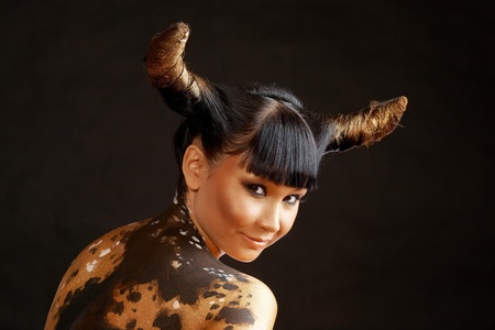 Portrait of female with horns looking at cameraの写真素材