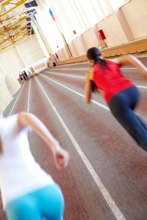 Gymnasium with blurred running silhouettesの写真素材