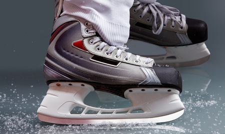 Close-up of skates on player feet during ice hockeyの写真素材