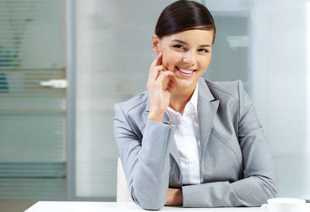 Image of young good-looking employer at the table の写真素材