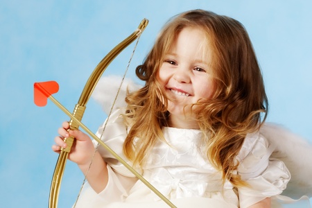 Cute female cupid holding bow の写真素材