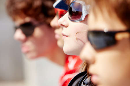 Portrait of several teens standing in row with focus on stylish girlの写真素材