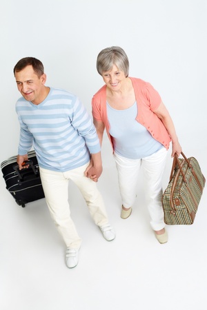 Portrait of happy senior couple with baggageの写真素材