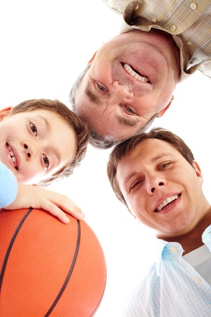 Below view of father, boy with ball and a grandfatherの写真素材
