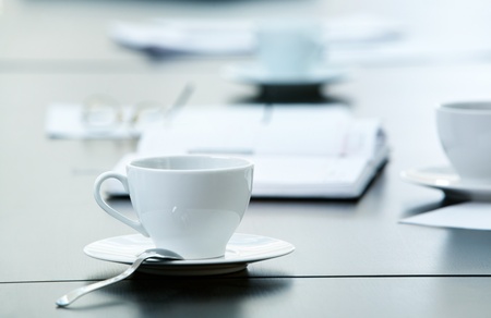 Morning workplace: cup of coffee and business objects on the table の写真素材