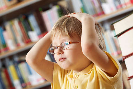 Portrait of clever boy touching his head