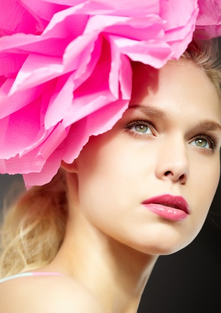 Gorgeous woman with pink flower by headの写真素材