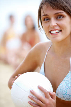 Portrait of fresh woman with ball looking at camera on summer vacationsの写真素材