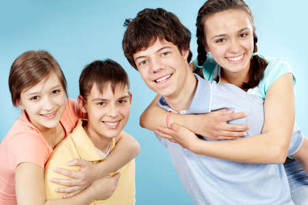 Portrait of two teenage couples looking at camera and smiling