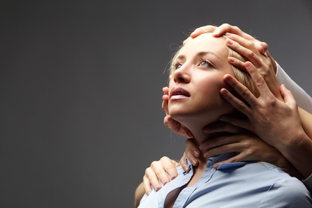 Portrait of a young businesswoman restrained by several handsの写真素材