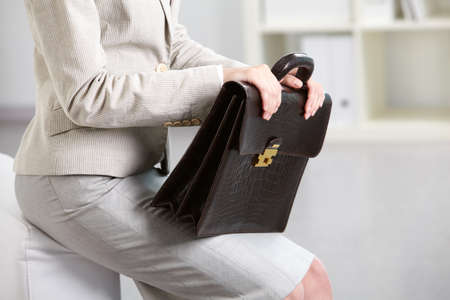 Close-up of businesswoman holding briefcaseの写真素材