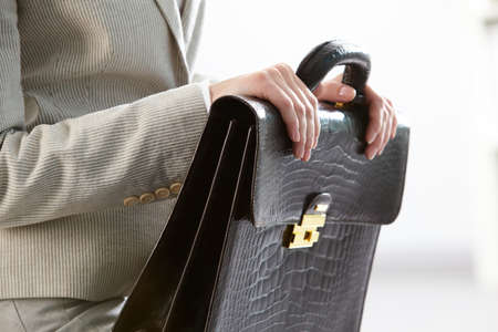 Close-up of businesswoman holding briefcase