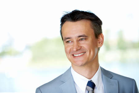 Face of happy businessman looking aside