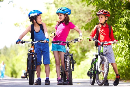 Portrait of three little children with their bikes 