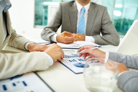 Image of human hands with pens over business documents at meetingの写真素材
