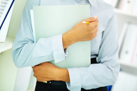 Close-up of businesswoman holding folder in handsの写真素材