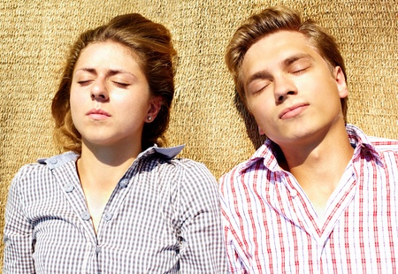 Portrait of young couple having a napの写真素材
