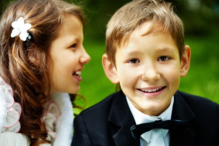 Portrait of boy groom looking at camera with his bride near by の写真素材