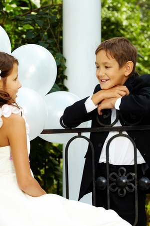 Portrait of boy groom speaking to his cute bride の写真素材