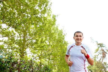 Image of positive sportsman running on summer dayの写真素材