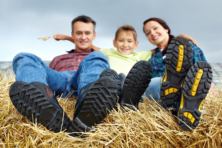 Happy family of three spending time in countryside