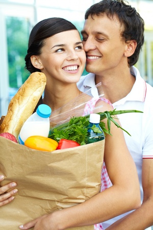 Portrait of a happy couple with foodstuff の写真素材