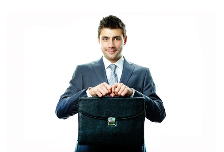 Portrait of attractive businessman with briefcase looking at cameraの写真素材