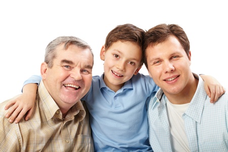 Portrait of a father, grandfather and son embracing
