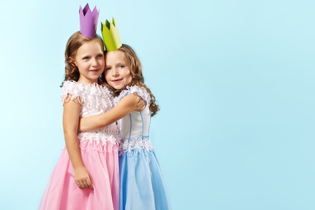 Portrait of smart girls in beautiful dresses and crownsの写真素材