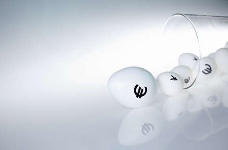 Image of glass containing eggs with euro and yen signs