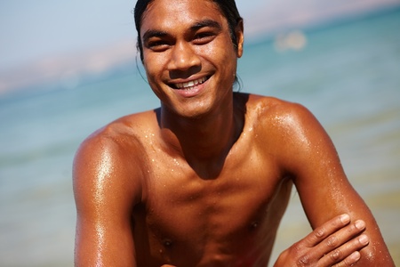 Young man looking at camera during summer restの写真素材