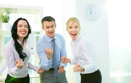 Business people looking at camera and expressing their successの写真素材