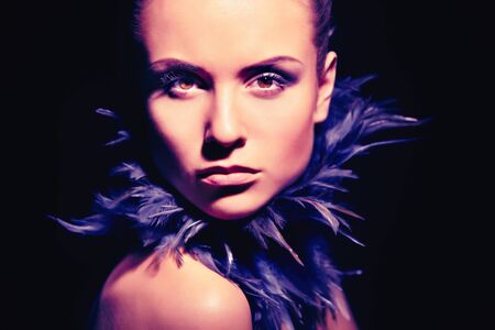 Image of gorgeous woman looking at camera on black background
