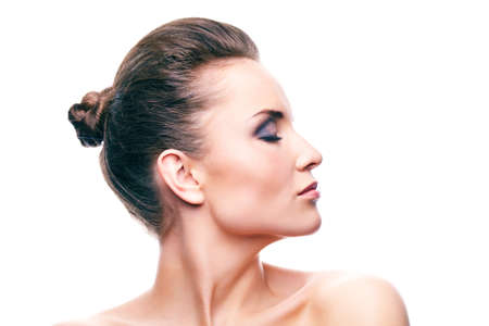 Woman with professional make-up in profile, isolated on white background