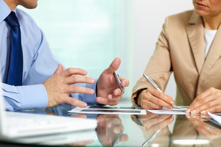 Business people sitting together holding a discussion concerning new strategic movementsの写真素材