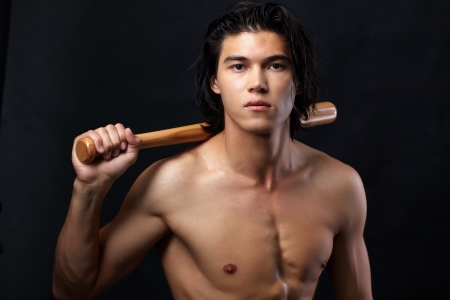 Image of shirtless man with bat looking at cameraの写真素材