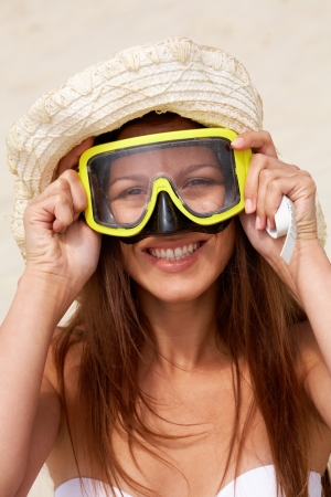 Girl wearing a scuba mask having fun on the beach の写真素材