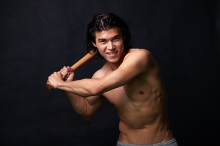 Sexy baseball player aiming a blow with a batの写真素材
